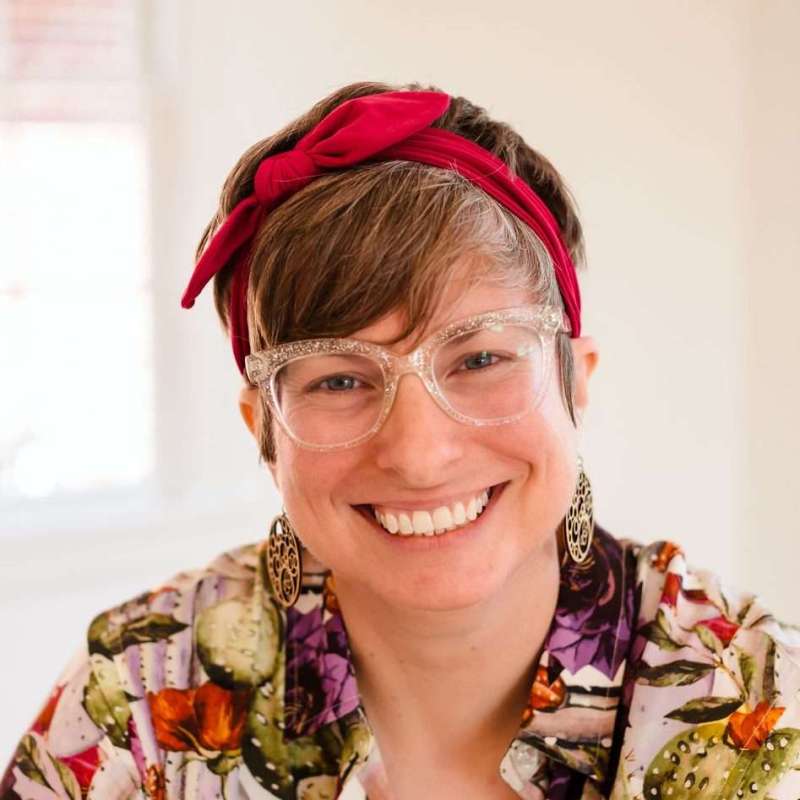 Sara Thompson with glasses and a head band